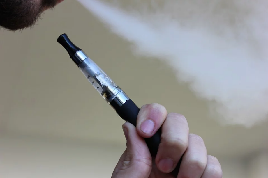 a person holding a vaporizer stick