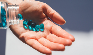 holding blue tablets